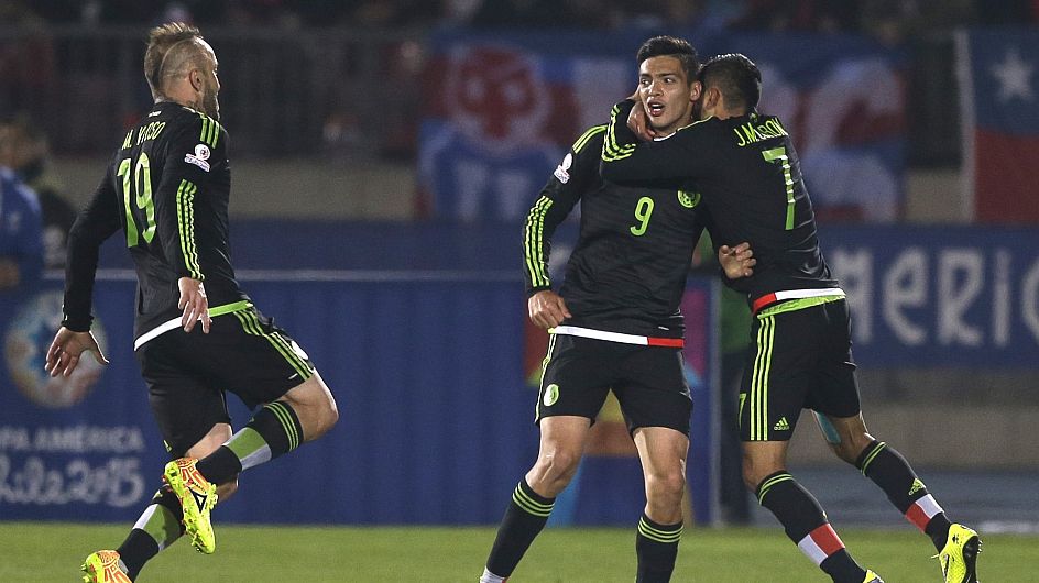 Mexico's Raul Jimenez, center, celebrates with teammates after scoring during a Copa America Group A soccer match against Chileat El Nacional stadium in Santiago, Chile, Monday, June 15, 2015. (AP Photo/Ricardo Mazalan)