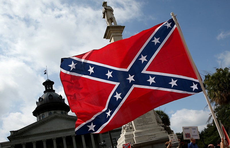 COLUMBIA, SC - JUNE 27: Demonstrators protest at the South Carolina State House calling for the Confederate flag to remain on the State House grounds June 27, 2015 in Columbia, South Carolina. Earlier in the week South Carolina Gov. Nikki Haley expressed support for removing the Confederate flag from the State House grounds in the wake of the nine murders at Mother Emanuel A.M.E. Church in Charleston, South Carolina.   Win McNamee/Getty Images/AFP