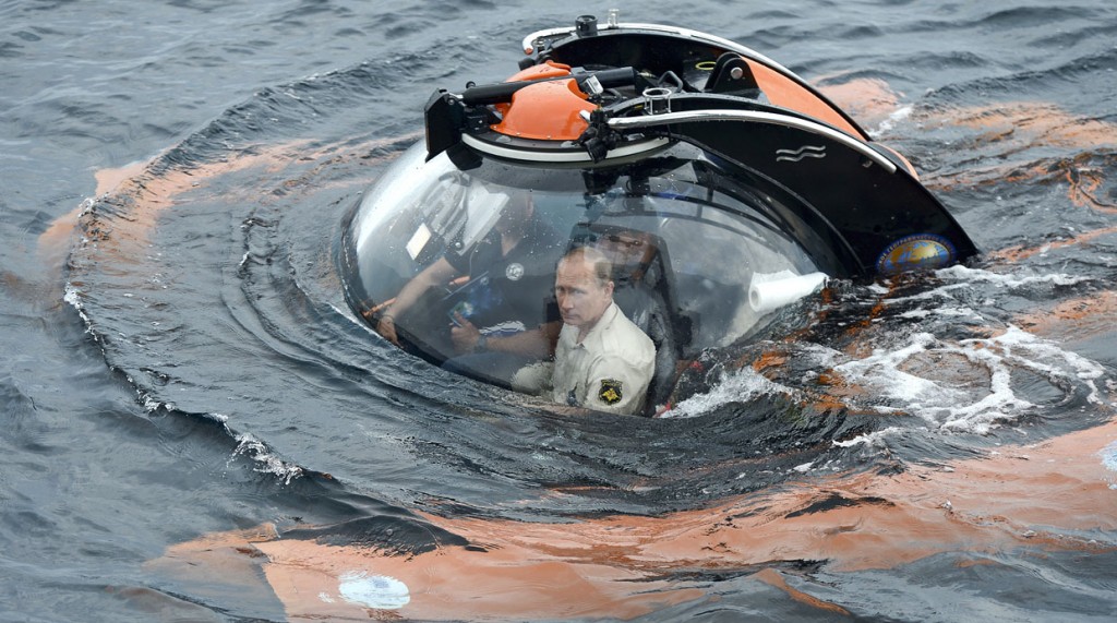 Russian President Vladimir Putin, centre, sits on board a bathyscaphe as it plunges into the Black sea along the coast of Sevastopol, Crimea, Tuesday, Aug. 18, 2015. President Vladimir Putin plunged into the Black Sea to see the wreckage of a sunk ancient merchant ship which was found in the end of May. (Alexei Nikolsky/RIA-Novosti, Kremlin Pool Photo via AP)